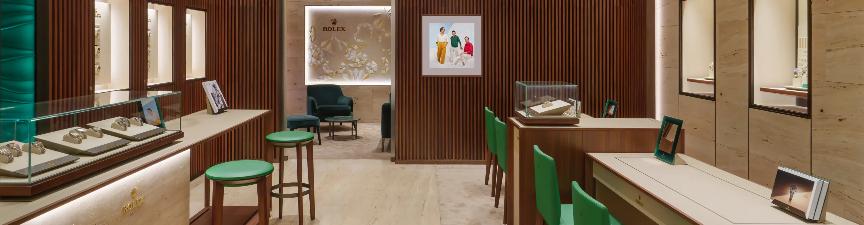 Rolex displays with green chair and stools in front for viewing.